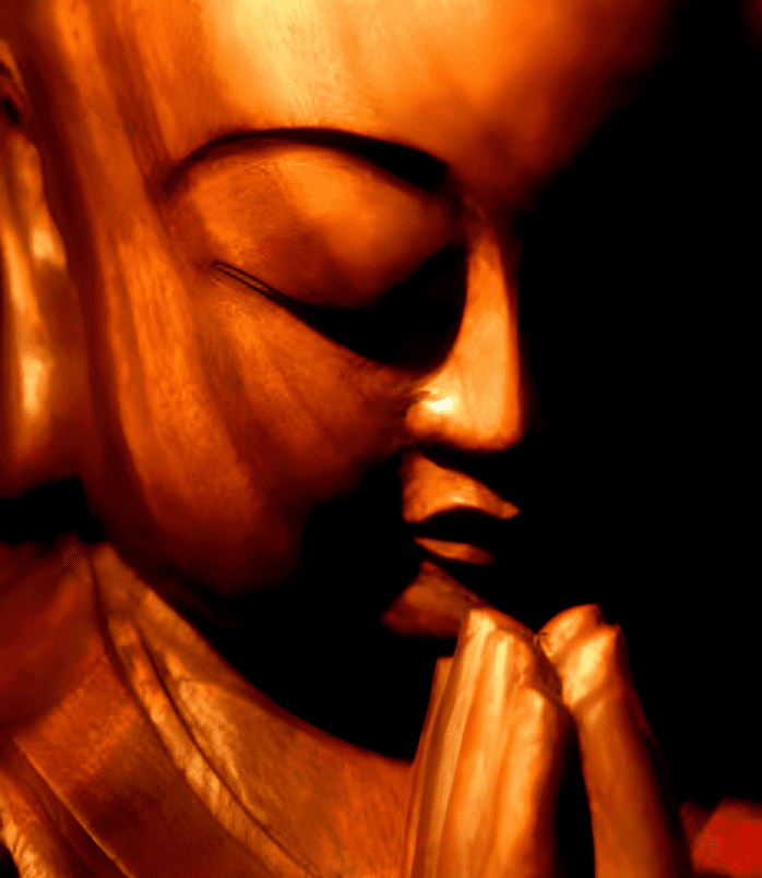 A statue of buddha is shown in the dark.